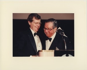 Two men smiling at podium