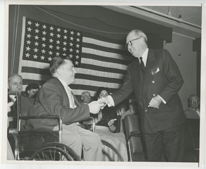 Jeremiah Milbank, Sr. handing gift to client at Institute Day