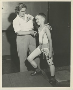 Boy stepping up stairs during physical rehabilitation