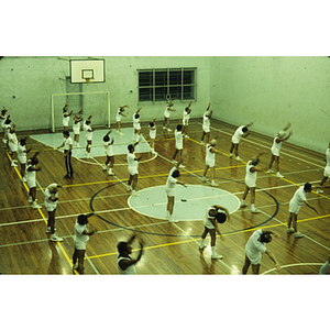 People stretching on a basketball court