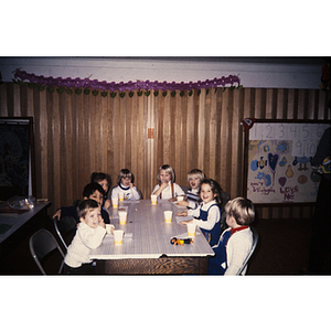 Young children at a table eating a snack