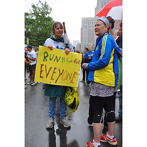 Woman holds sign by One Run finish line