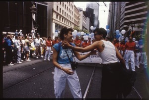 Two women in front the San Francisco Gay Men's Chorus at the San Francisco Pride Parade