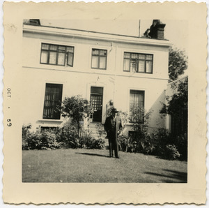 W. E. B. Du Bois standing in front of an unidentified house