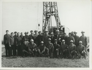 Shirley Graham and David Du Bois standing with a group of oil workers