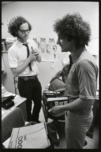Abbie Hoffman and unidentified man looking at copy of Steal This Book