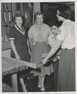 Occupational therapist and young man demonstrating a brace for two female onlookers