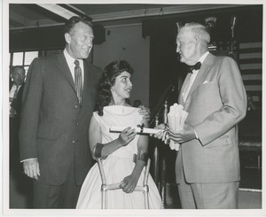 Bruce Barton handing diploma to client with an unidentified man at Institute Day