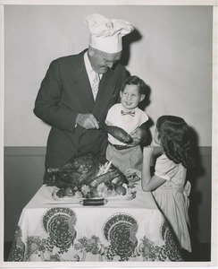 Bruce Barton feeding turkey to young clients