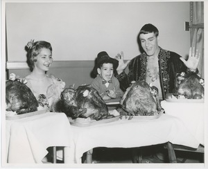 Performers and young client at Thanksgiving celebration