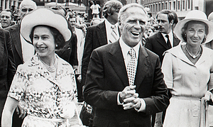 [Queen Elizabeth II, Mayor Kevin White, and Kathryn White walking in a parade]