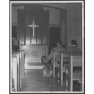 Young men in a chapel with his service dog