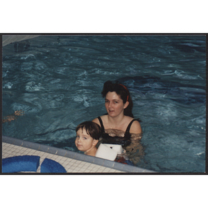 Adult and child swimming in pool at West Roxbury branch