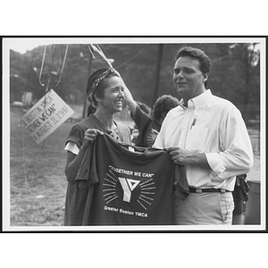 Two staff members holding up YMCA shirt on Camp Day