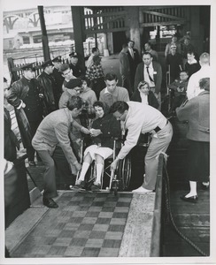 Woman in wheelchair boarding ship