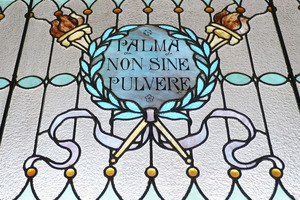 Dickinson Memorial Library: close-up of stained glass window 'Palma non sine pulvere'