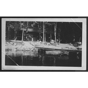 View of cabin from lake at unidentified YMCA camp