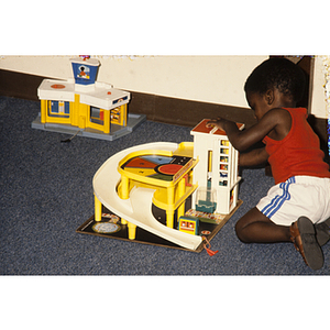 Child playing with a toy garage