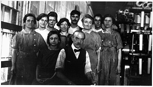 A group of female and textile workers with their overseer.