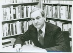 Suffolk University Professor Stanley M. Vogel (CAS) - Department Chair - English, seated with bookshelf in background, circa 1970s