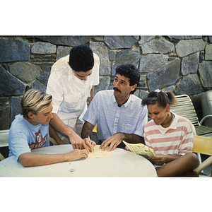 Youth and instructor sitting at table looking at documents