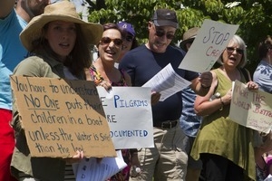 Pro-immigration protesters and signs outside the Chatham town offices building : taken at the 'Families Belong Together' protest against the Trump administration's immigration policies