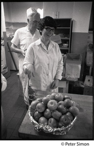 Cafeteria workers with bowl of apples at Shelton Hall, Boston University