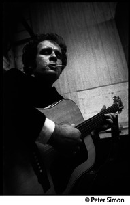 Tim Hardin smoking a cigarette and playing guitar at the Unicorn Coffee House, Boston, Mass.