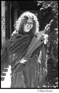 Usha (Cathy Brown): three-quarter length portrait posed with a dulcimer