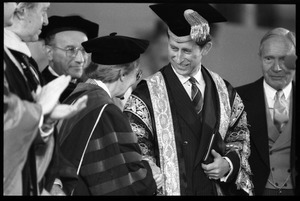 Prince Charles in academic regalia, greeting Professor Emily Vermeule at the 350th anniversary celebration of Harvard University
