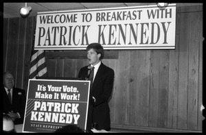 Patrick Kennedy campaign breakfast of ham and eggs at Caruso's Restaurant: Kennedy speaking at the podium beneath a sign reading 'Welcome to breakfast with Patrick Kennedy'