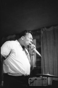 James Cotton at Club 47: James Cotton onstage, holding his harmonica and microphone with one hand