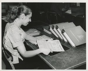 Woman assembling manuals