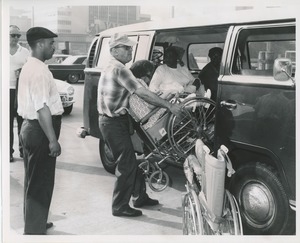 Woman in wheelchair loaded into van