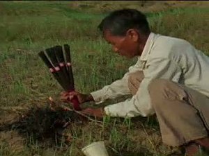 Lighting Incense in a Field