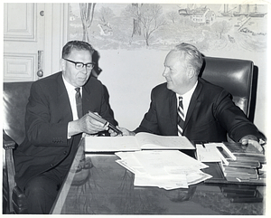 Mayor John F. Collins in his office with Daniel Minogue handing him a book about Boston