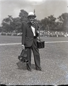 Franklin I. Jordan, photographer, wearing a festive hat and tie, with cameras