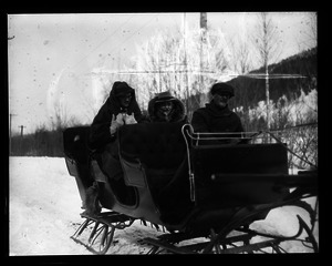 Paul Whelton riding in a sleigh