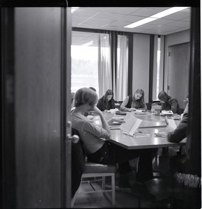 UMass Amherst students sitting around a classroom table, reading