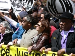 Al Sharpton (left) and Susan Sarandon at the head of the antiwar marchers in the streets of New York, with signs and banners opposing the war in Iraq