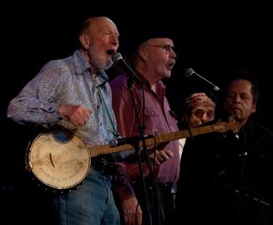 Pete Seeger performing on stage with Tom Paxton and Garland Jeffreys (from left) at the Earth Day concert