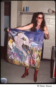 MUSE concert and rally: unidentified woman holding up batik-dyed cloth backstage at the MUSE concert