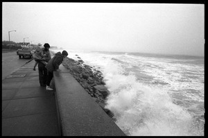 Judy Salonia, her husband Vincent, and daughter Ashley (4) look over the Narragansett seawall at crashing waves