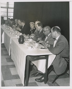 Group of people eating at long table