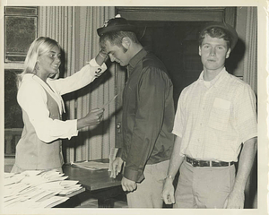Presenting beanies to a new student (ca. 1969)
