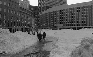 Snow piles and pedestrians in Boston City Hall Plaza