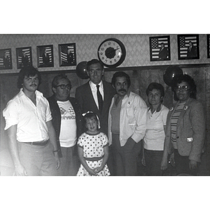 Mayor Raymond Flynn poses with five adults and a young girl at the Wigglesworth Street rally