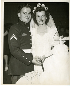 Charles Santos Jr. and Ruth Cassidy posing with wedding cake