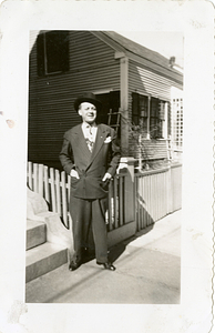 Manny Dias posing in front of fence