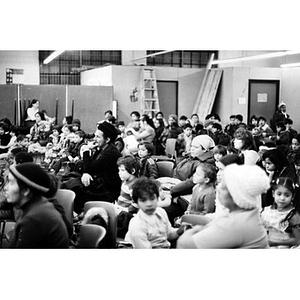 Audience, consisting mostly of Hispanic American children and some adults, watches a Three Kings' Day pageant at La Alianza Hispana.